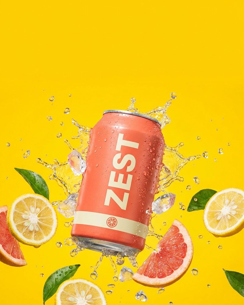 Generated product photo: coral Zest soda can bursting through a splash of sparkling water on a yellow backdrop